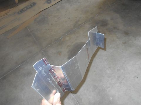 1992 Ford Bronco - A custom metal bracket is shown, possibly for a vehicle part, against a workshop floor.
