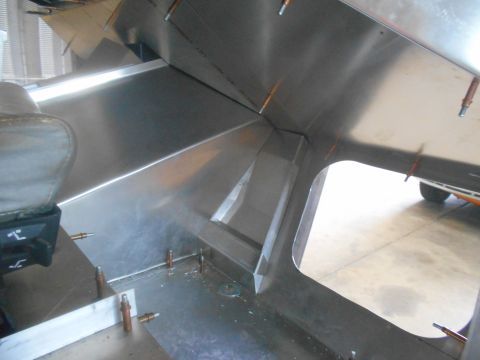 1992 Ford Bronco - The interior of a vehicle shows exposed metal construction with a partial seat visible.
