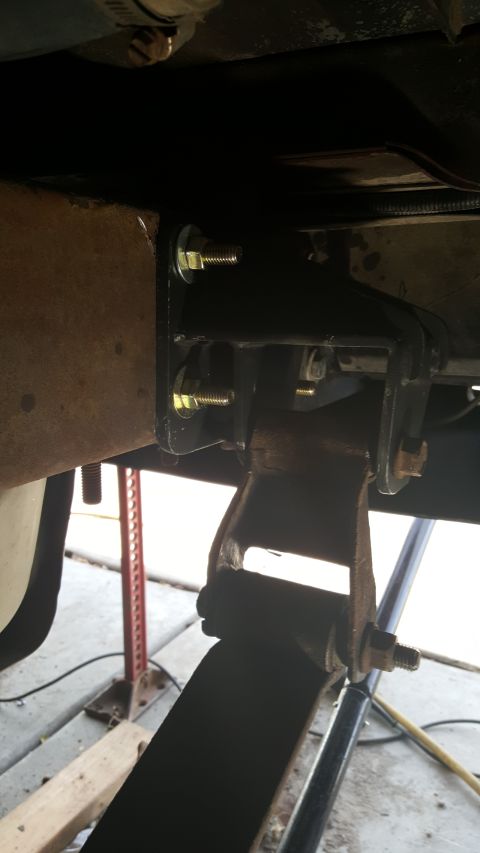 1996 Ford Bronco - Custom shackle flip bracket installation on a vehicle's leaf spring suspension.
