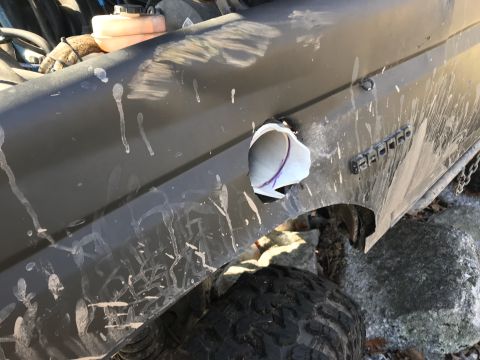 1989 Ford Bronco - The side of a 1989 Ford Bronco shows damage to the fender, with the "BRONCO" badge still visible.
