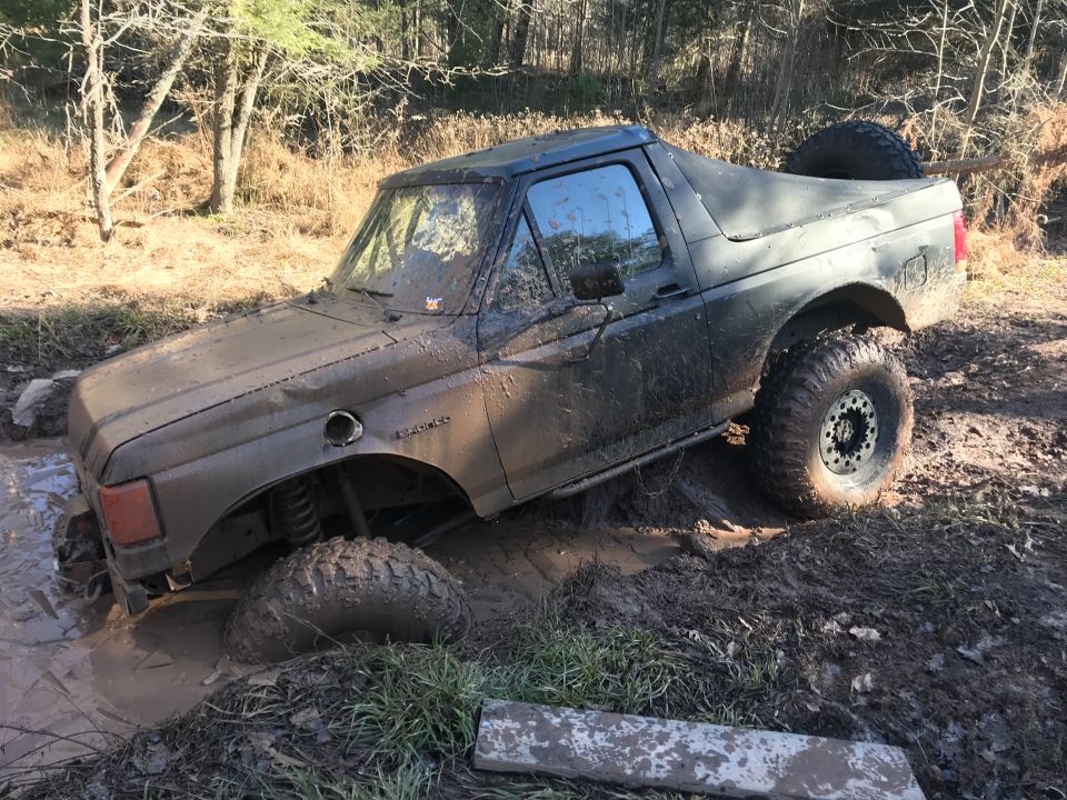 1989 Ford Bronco stuck in mud, front wheel deep in water