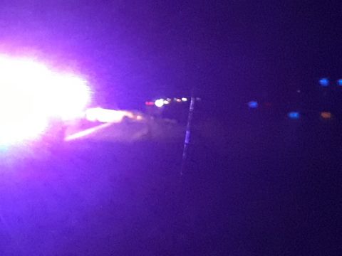 2003 Ford Mustang - A dark scene illuminated by bright lights, suggesting an incident occurred on the road at night.