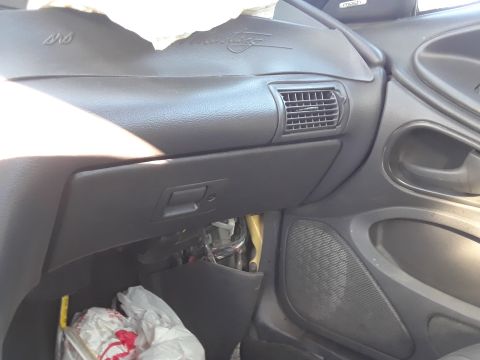 2003 Ford Mustang - Interior view of a 2003 Ford Mustang, focusing on the dashboard and passenger side.