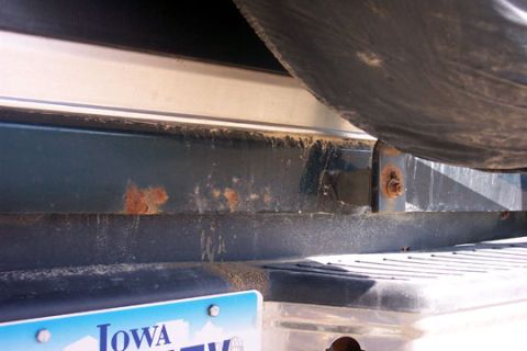 1995 Ford Bronco - Close-up of a vehicle's rear bumper and spare tire, showing signs of rust and wear.
