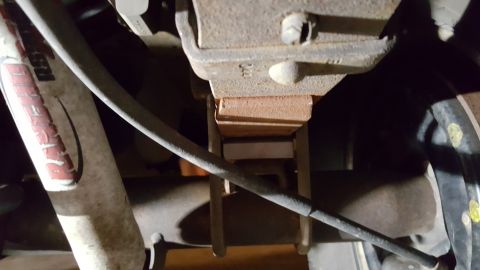 1996 Ford Bronco - Close-up view of a vehicle's suspension system, focusing on a shock absorber and bracket.