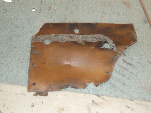 1962 MG B - This is a damaged interior door panel, likely from an older vehicle, showing significant wear and tear.