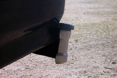 1995 Ford Bronco - Close-up of a rear bumperette on a black vehicle, showing its gray accents and textured surface.