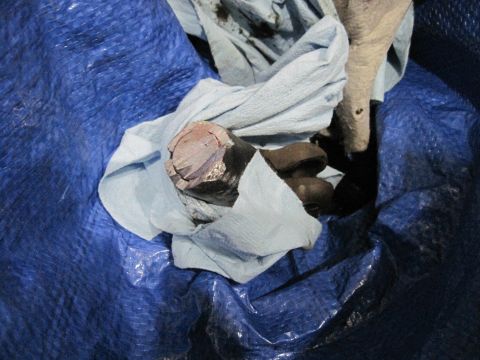 1994 Cadillac Fleetwood - A close-up view of a steering box part, wrapped in cloth and placed on a blue tarp.