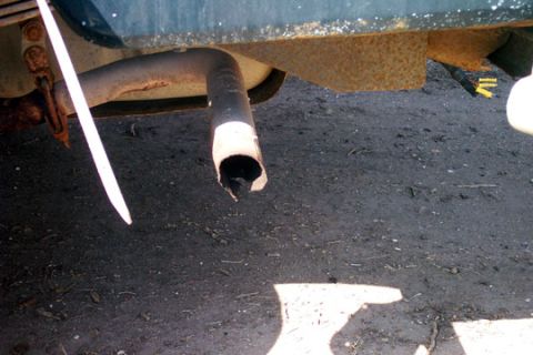 1995 Ford Bronco - The vehicle's exhaust pipe appears to be damaged and bent, with a jagged opening at the end.