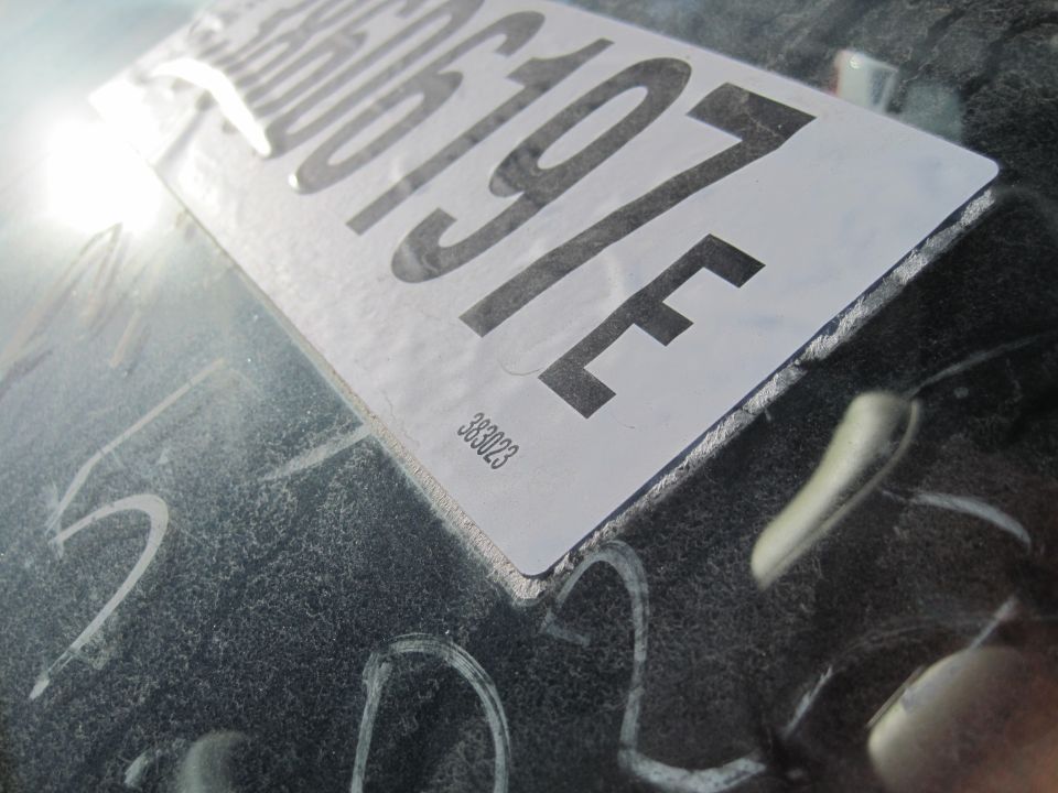 License plate with numbers 386197F and code 383023