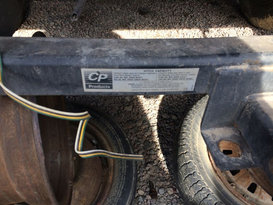 Trailer hitch with CP Products label showing hitch capacity information
