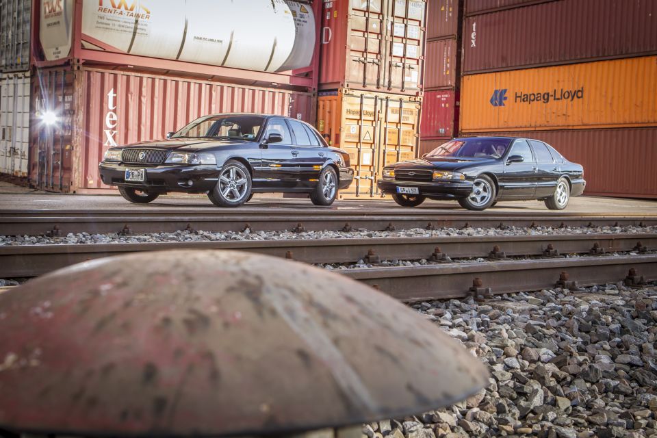 Black 2003 Mercury Marauder parked on train tracks with another sedan