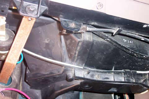 1995 Ford Bronco - Underside view of a black plastic heater/HVAC duct assembly with handwritten marking 5F140 and wiring.