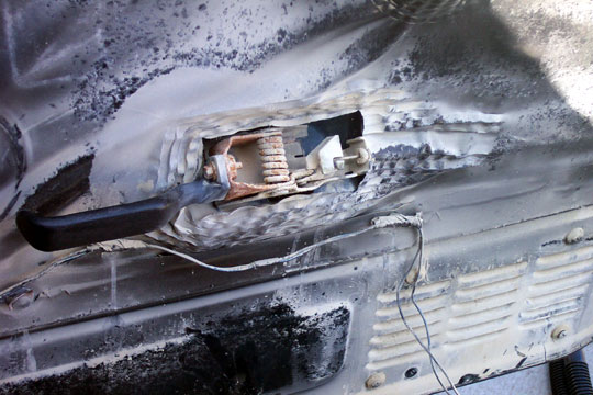 Welded body panel repair with bolt-mounted bracket and rust on vehicle sheet metal