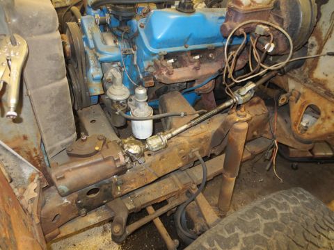 1967 Ford F-250 - The engine bay of an older vehicle shows the steering mechanism and front suspension components.