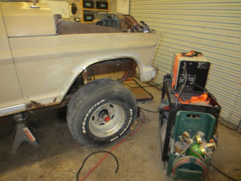 1967 Ford F-250 - A truck is on jack stands with a welding machine next to it, suggesting repair work is in progress.