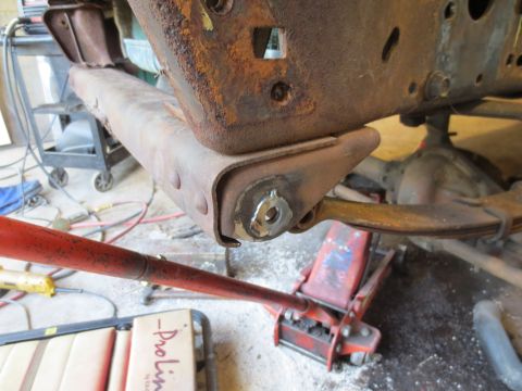 1967 Ford F-250 - Rusted truck frame and suspension components are visible, held up by a jack.