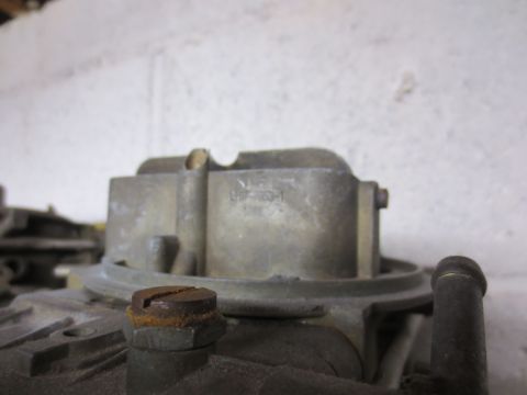 1967 Ford F-250 - Carburetor part with visible stamped numbers, likely from an older vehicle.