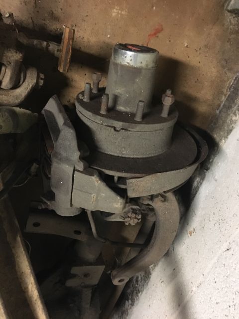 1967 Ford F-250 - A close-up view of a truck's hub and brake assembly, showing wear and rust on its components.