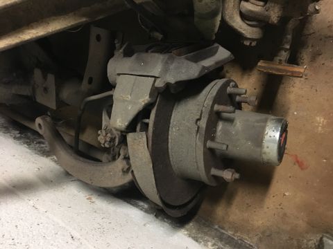 1967 Ford F-250 - Close-up view of a vehicle's rear axle, showing the brake drum and hub assembly.