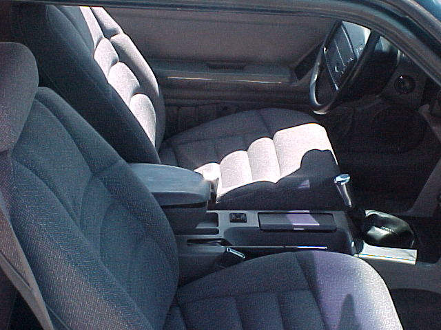 1992 Ford Mustang interior with gray cloth seats, center console, and steering wheel visible