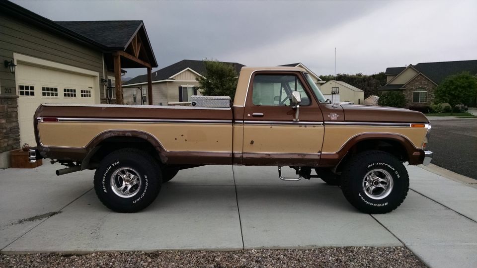 Side view of a 1979 Ford F-150 pickup truck, brown and tan two-tone paint, lifted suspension