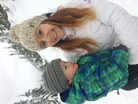 1995 Jeep Wrangler - A woman and a baby are enjoying a snowy day outdoors, bundled up in warm winter clothing.