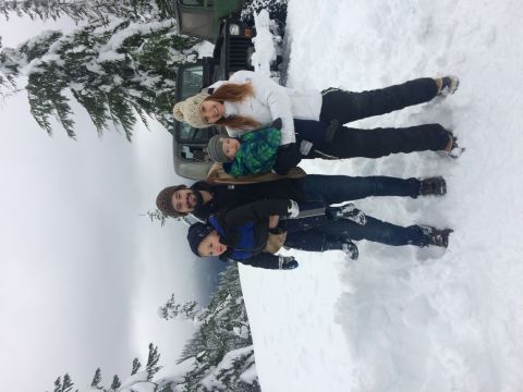 1995 Jeep Wrangler - A family poses in the snow next to a green Jeep YJ.