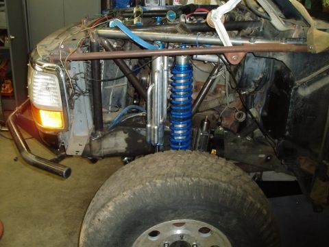 1994 Ford Bronco - Custom off-road truck front end modification with visible suspension components and roll cage structure.