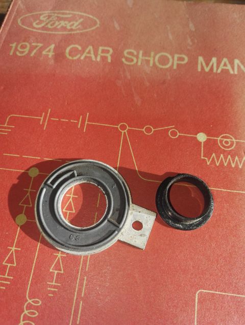 1974 Ford Ranchero - A 1974 Ford Car Shop Manual is shown with two unidentified automotive parts.