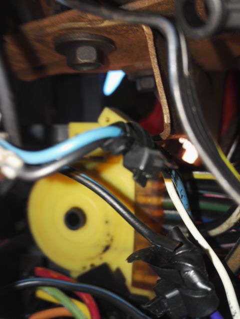 1974 Ford Ranchero - A detailed view of automotive wiring and a yellow component, likely part of a larger system.