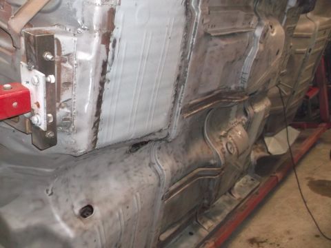 1964 Ford Galaxie - Close-up view of a car's underbody, revealing structural components and metalwork.