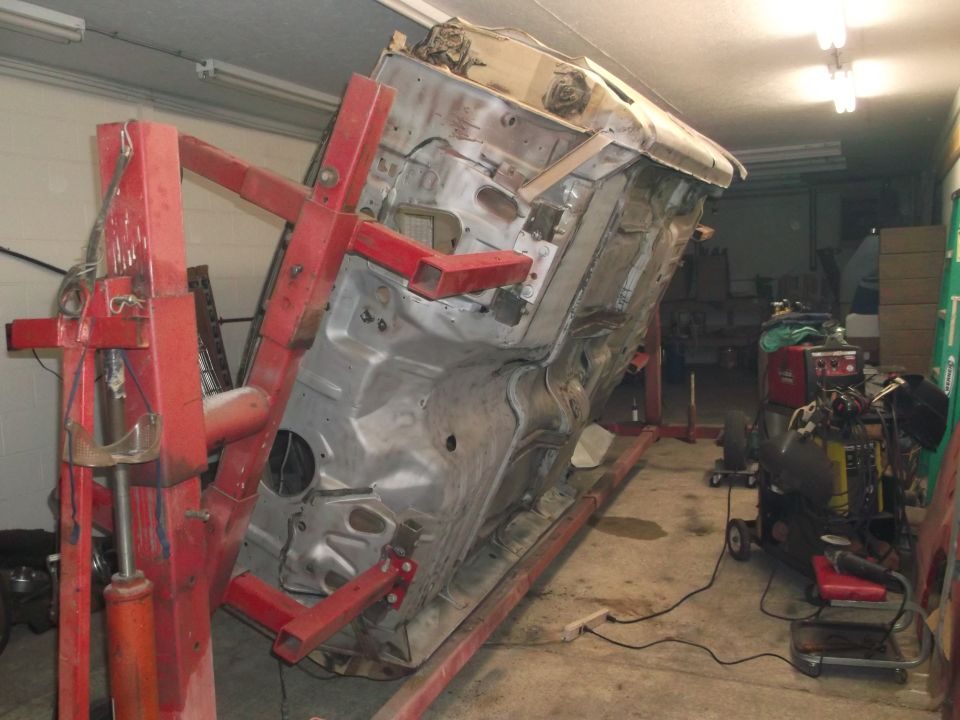 1964 Ford Galaxie body on rotisserie lift, underside view