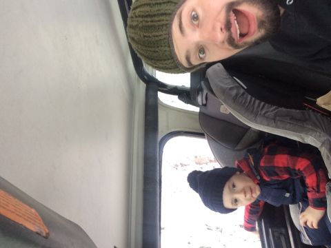 1995 Jeep Wrangler - Man and child inside a vehicle during a snow run.