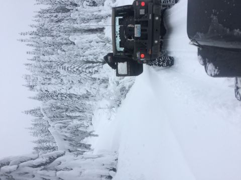 1995 Jeep Wrangler - A Jeep Wrangler navigates a snow-covered trail with another vehicle nearby.