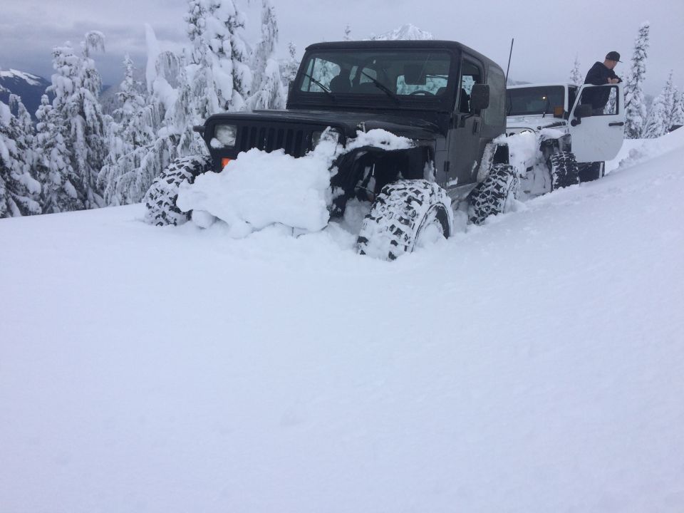 1995 Jeep YJ stuck in deep snow with another Jeep behind it