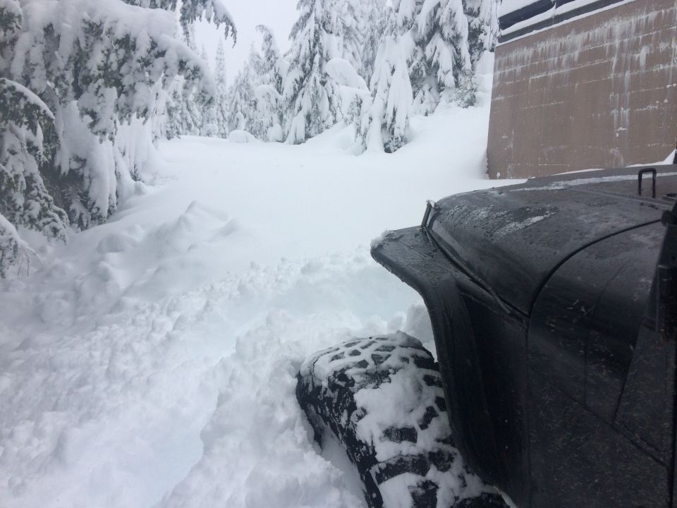 Black 1995 Jeep YJ in deep snow, front fender and tire visible