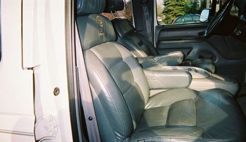 1996 Ford C-250 (Centurion Conversions) - The plush leather captain's chairs and center console are visible in this interior shot.