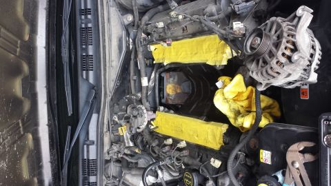 2005 Mercury Grand Marquis - Engine bay detail with yellow tape applied to intake manifold components. Supermotors.net logo present.