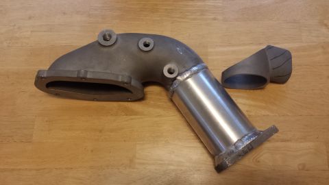 2005 Mercury Grand Marquis - Close-up of an exhaust manifold part with an attached metal pipe.