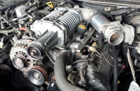 2005 Mercury Grand Marquis - This engine bay features a prominent supercharger and numerous electrical and vacuum lines.