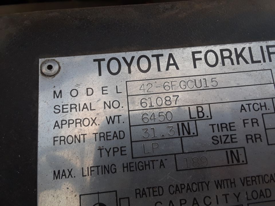 Toyota forklift data plate showing model, serial number, weight, and tire information.