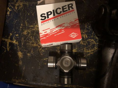 1995 Ford F-150 - A Spicer U-joint is shown next to its box, which reads "SPICER DRIVETRAIN PRODUCTS" and "DANA". The U-joint has part number "5-760X" visibl…