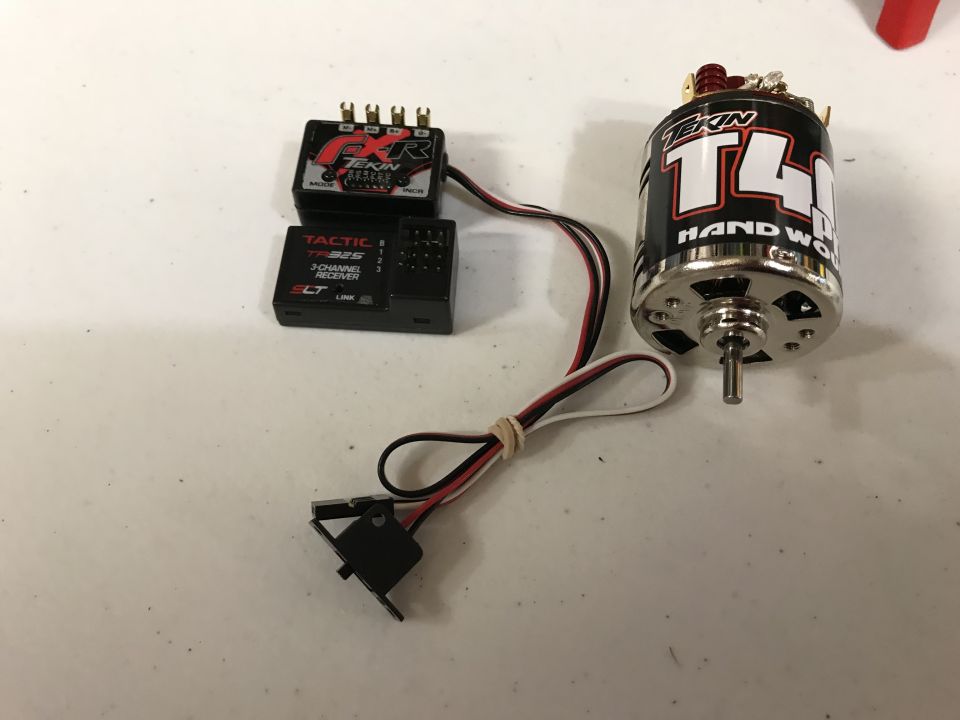 Tekin T4 motor and Tactic TR325 receiver on a white surface