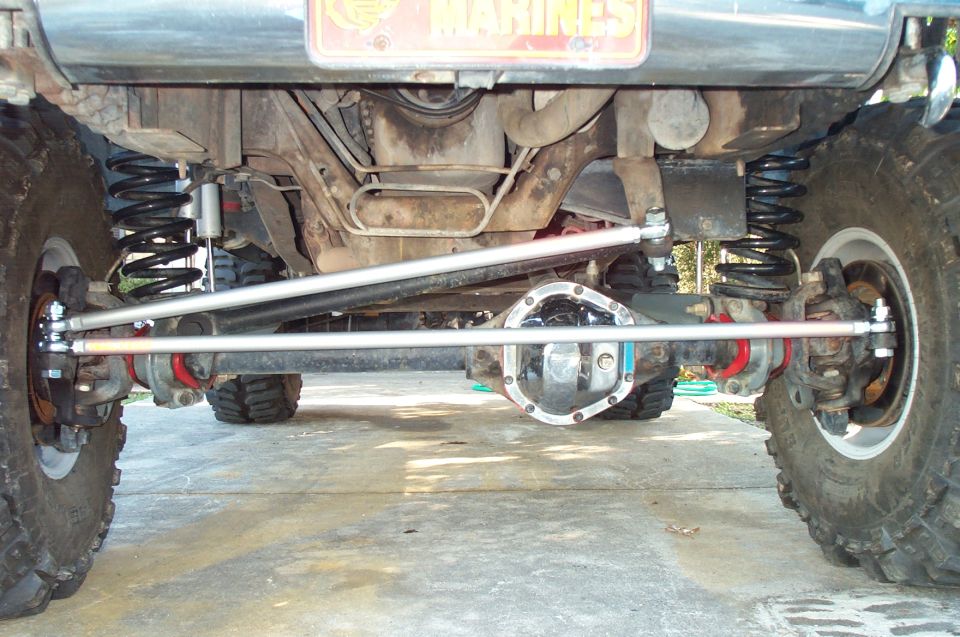 Front solid axle with crossover steering, coil springs and chrome diff cover on lifted 4x4
