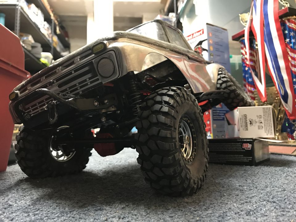 RC rock crawler with weathered metallic body and large off-road tires.