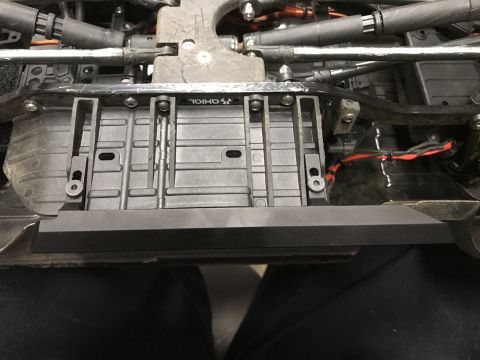1989 Ford Bronco - Close-up view of the undercarriage of a remote-controlled vehicle, showing its mechanical components and wiring.