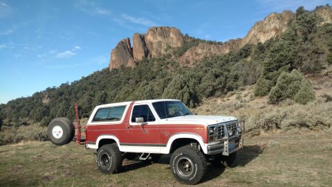1981 Ford Bronco - This Ford Bronco is parked outdoors with a rocky mountain landscape behind it.