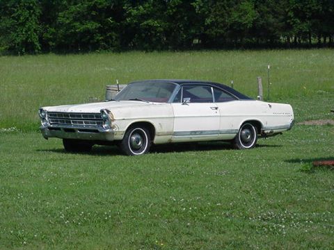 White 1967 Ford Custom Wagon with black roof parked on grass