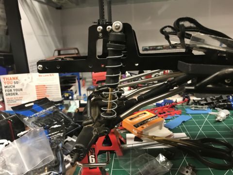 1989 Ford Bronco - Close-up view of an RC car's suspension system, a shock absorber and coiled springs.